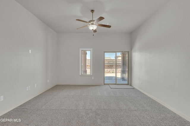 spare room with carpet flooring, ceiling fan, and baseboards