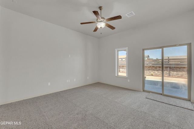 spare room featuring carpet, ceiling fan, and baseboards