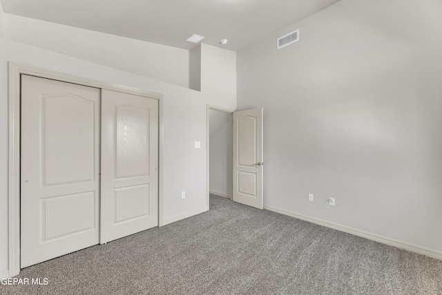 unfurnished bedroom featuring carpet flooring, baseboards, and a closet