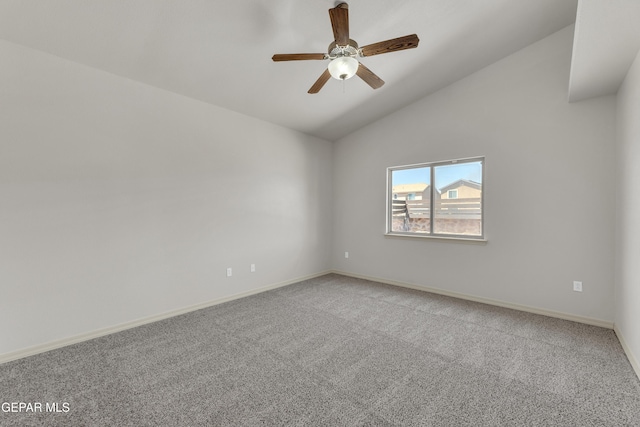 spare room with lofted ceiling, light carpet, a ceiling fan, and baseboards