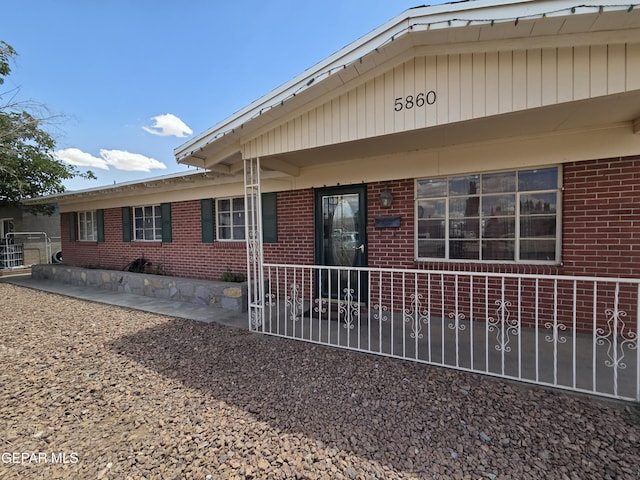 rear view of house with brick siding