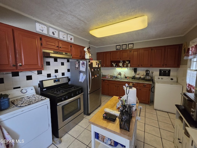 kitchen featuring washer / dryer, stainless steel appliances, under cabinet range hood, a sink, and a textured ceiling