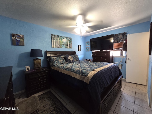 tiled bedroom featuring a textured ceiling, a textured wall, and ceiling fan