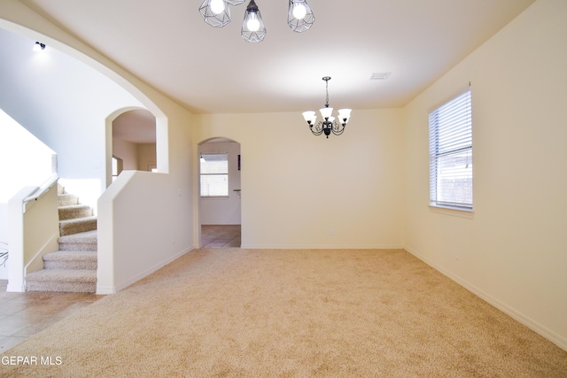 12093 Rathmore Dr, El Paso, TX 79928 - spare room with a chandelier, carpet flooring, arched walkways, and baseboards