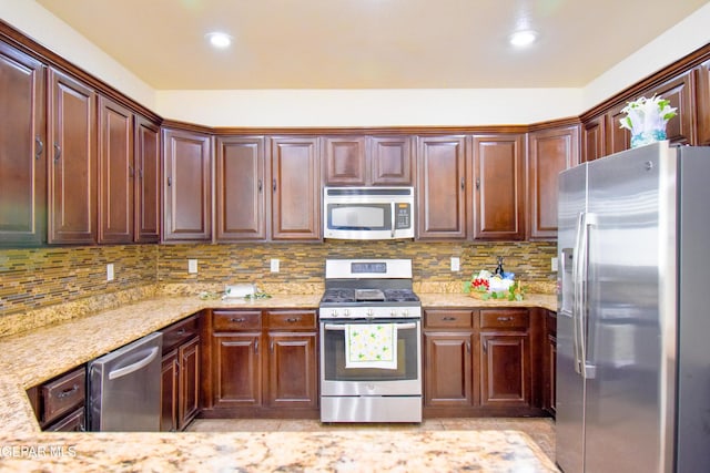 12093 Rathmore Dr, El Paso, TX 79928 - kitchen featuring stainless steel appliances, light stone countertops, tasteful backsplash, and recessed lighting
