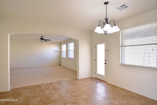 12093 Rathmore Dr, El Paso, TX 79928 - foyer featuring arched walkways, ceiling fan, a chandelier, light colored carpet, and baseboards