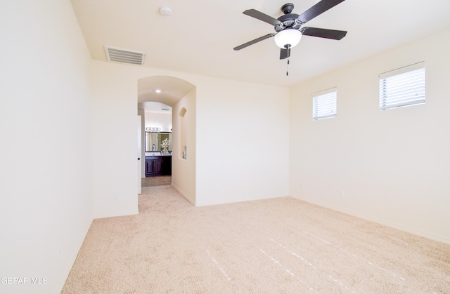 12093 Rathmore Dr, El Paso, TX 79928 - unfurnished room featuring ceiling fan, arched walkways, and light colored carpet