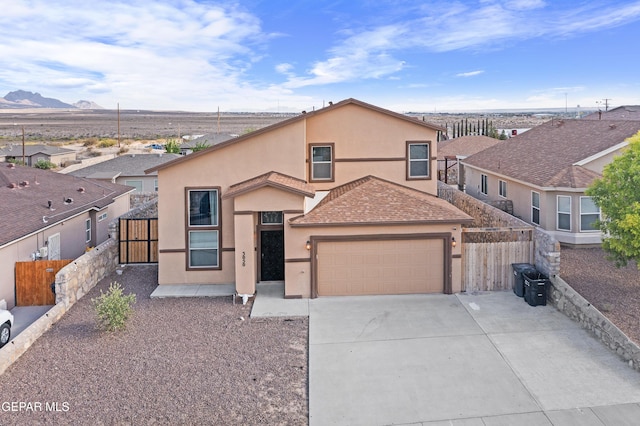 3050 Selene Vega Ave, Anthony, TX 79821 - view of front of house with stucco siding, fence, driveway, a garage, and a mountain view