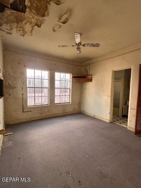 unfurnished room with a ceiling fan, carpet floors, and ornamental molding