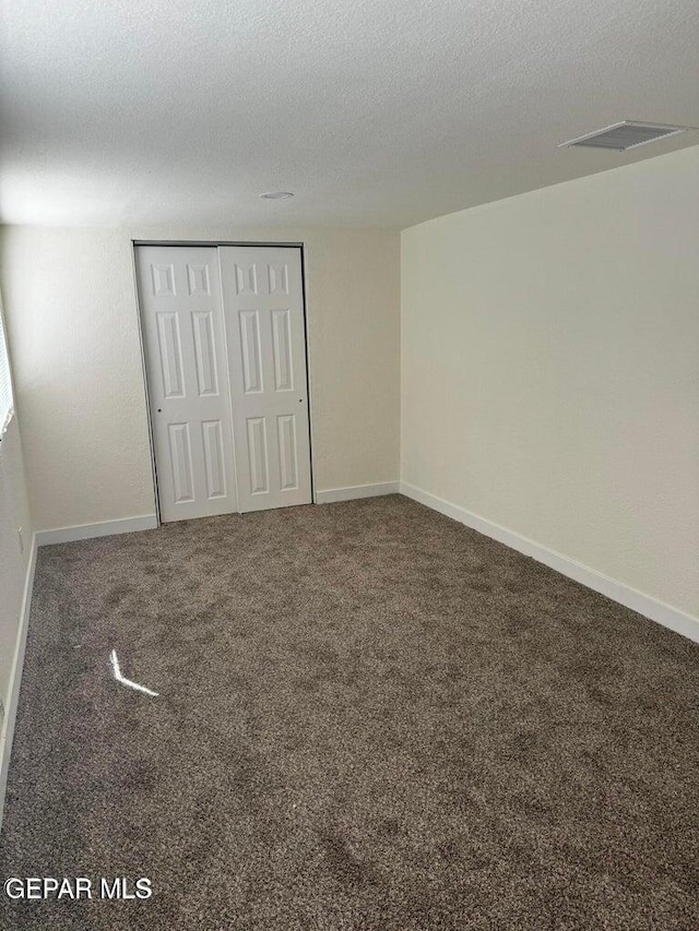 3512 Kemp Ave, El Paso, TX 79904 - unfurnished bedroom featuring a closet, a textured ceiling, and carpet flooring