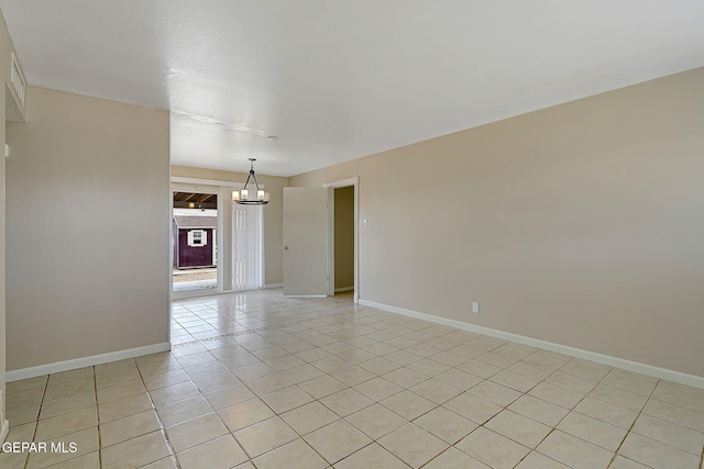 unfurnished room with a chandelier, light tile patterned floors, and baseboards