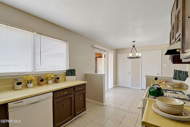 kitchen featuring white appliances, light tile patterned floors, dark brown cabinets, light countertops, and pendant lighting