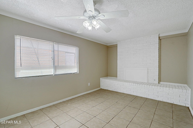 empty room with a textured ceiling, ceiling fan, and light tile patterned flooring