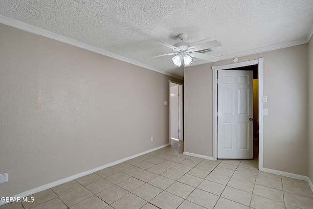 unfurnished bedroom with light tile patterned flooring, a textured ceiling, crown molding, baseboards, and ceiling fan