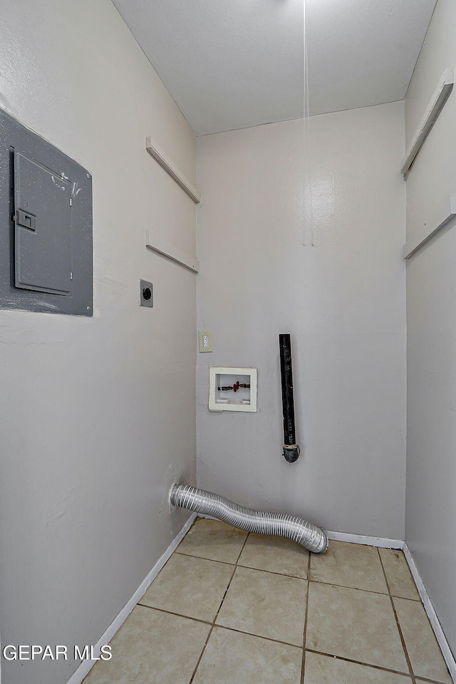 laundry room with hookup for an electric dryer, washer hookup, electric panel, tile patterned floors, and baseboards