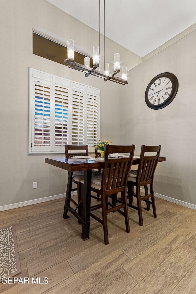 12289 Fresh Water Dr, El Paso, TX 79928 - dining area with a chandelier, wood finished floors, and baseboards