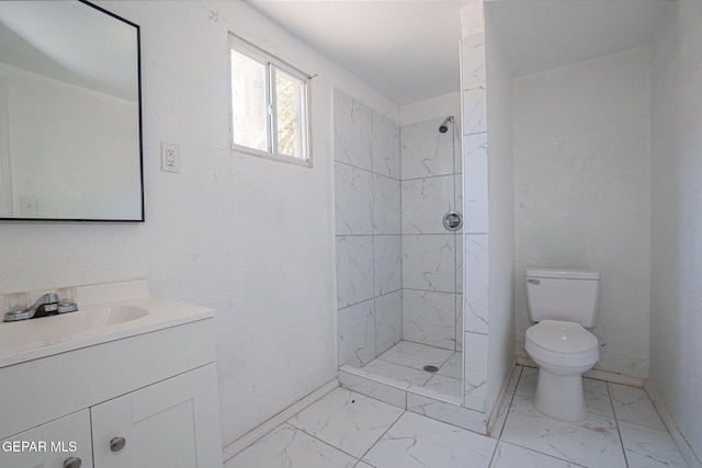 318 Austin St, Fabens, TX 79838 - full bath with toilet, vanity, a tile shower, marble look tiles, and baseboards