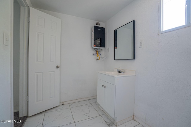 318 Austin St, Fabens, TX 79838 - bathroom with water heater, marble look tile flooring, vanity, and baseboards