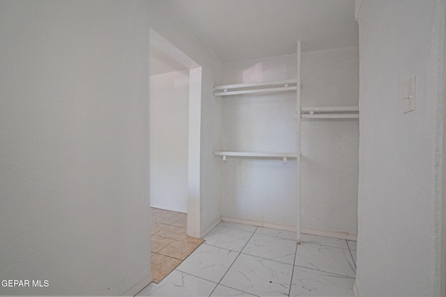 318 Austin St, Fabens, TX 79838 - walk in closet featuring marble finish floors