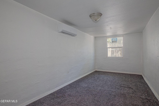 318 Austin St, Fabens, TX 79838 - carpeted spare room featuring a wall mounted air conditioner, a textured wall, and baseboards