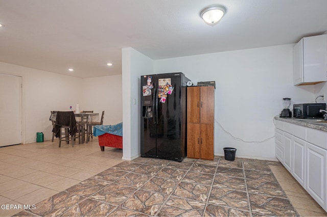 318 Austin St, Fabens, TX 79838 - kitchen with black appliances, white cabinetry, and recessed lighting