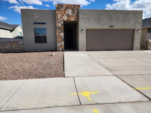 14508 Russell Borea, El Paso, TX 79938 - pueblo-style home with concrete driveway, a garage, and stucco siding