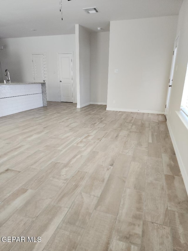 14508 Russell Borea, El Paso, TX 79938 - unfurnished living room featuring light wood finished floors, a sink, ceiling fan, and baseboards