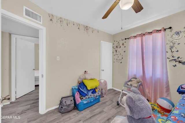 recreation room featuring a ceiling fan, wood finished floors, and baseboards