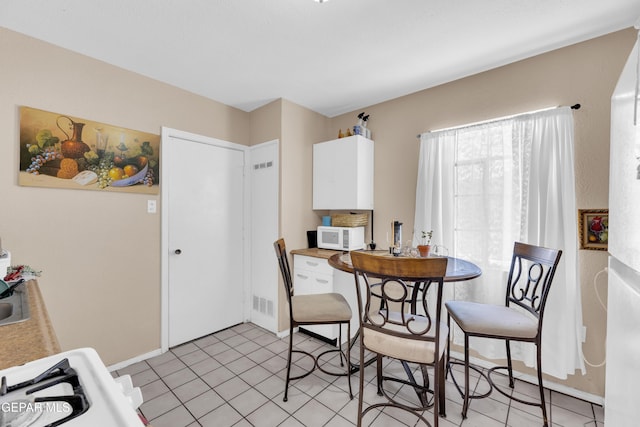dining space featuring baseboards