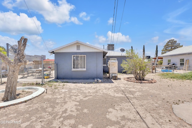 rear view of property featuring fence