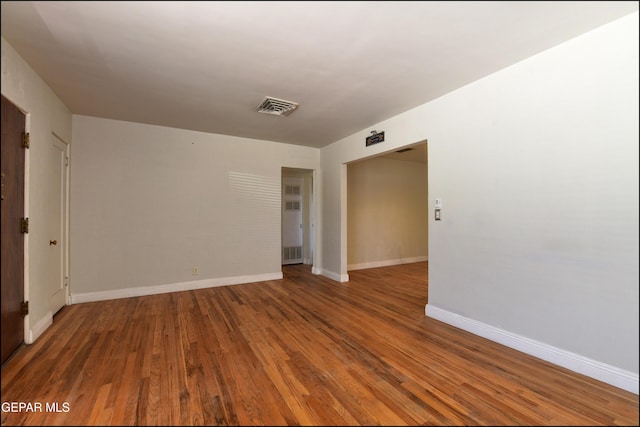 unfurnished room featuring wood finished floors and baseboards