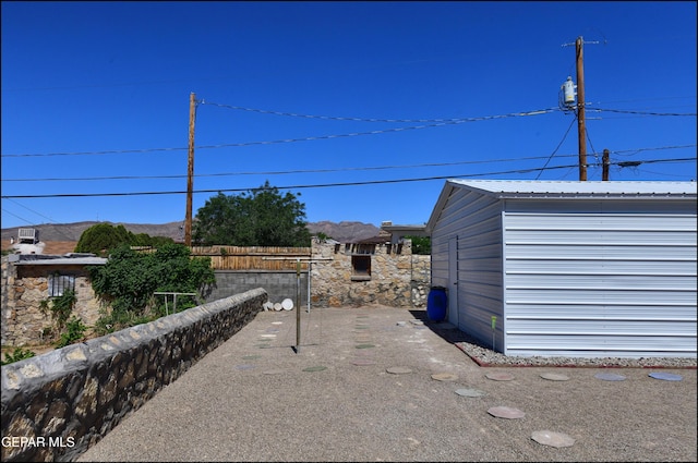 view of yard featuring an outbuilding and fence