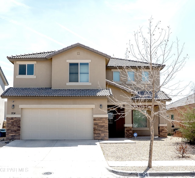 804 Spofforth Rd, El Paso, TX 79928 - view of front of property featuring stone siding, an attached garage, concrete driveway, and a tile roof