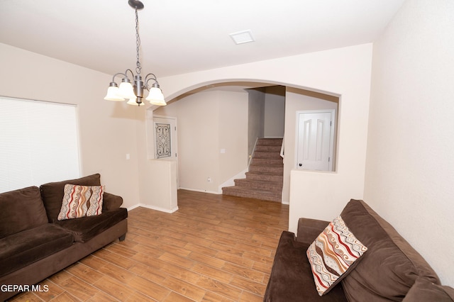804 Spofforth Rd, El Paso, TX 79928 - living area with arched walkways, a chandelier, light wood-style floors, stairs, and baseboards