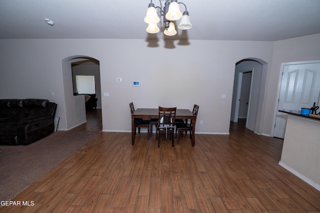 804 Spofforth Rd, El Paso, TX 79928 - dining area featuring arched walkways, a chandelier, wood finished floors, and baseboards