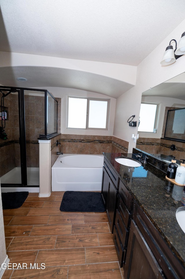 804 Spofforth Rd, El Paso, TX 79928 - full bathroom featuring a stall shower, plenty of natural light, a bath, and wood tiled floors