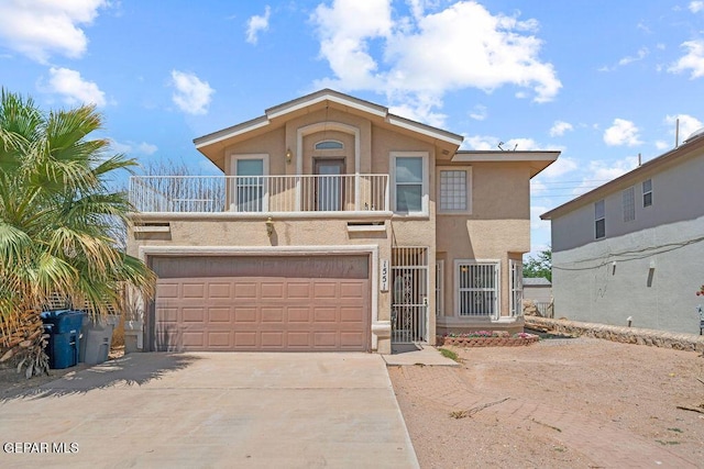 1551 Paseo Feliz Dr, El Paso, TX 79928 - view of front of property featuring a balcony, stucco siding, driveway, and a garage