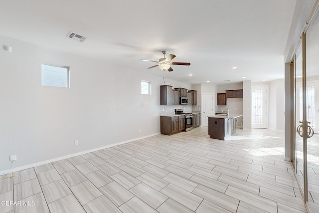 14813 Pebble Hills Blvd, El Paso, TX 79938 - unfurnished living room featuring a ceiling fan, baseboards, a sink, and recessed lighting