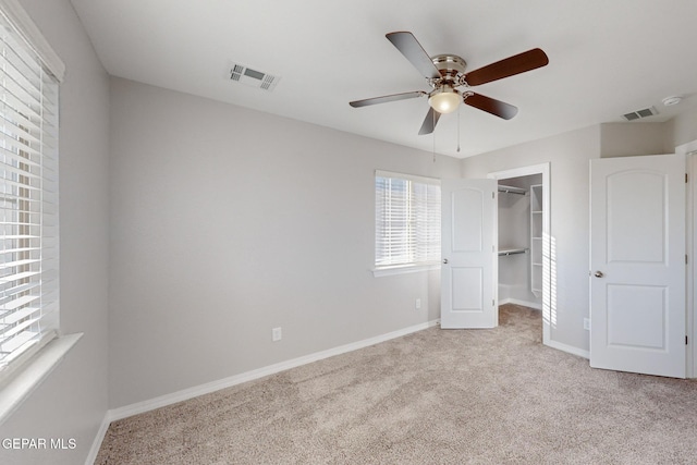 14813 Pebble Hills Blvd, El Paso, TX 79938 - unfurnished bedroom featuring light colored carpet, baseboards, a spacious closet, a closet, and a ceiling fan