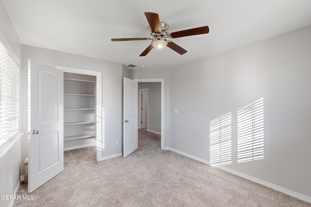 14813 Pebble Hills Blvd, El Paso, TX 79938 - unfurnished bedroom with carpet, a spacious closet, baseboards, a closet, and a ceiling fan