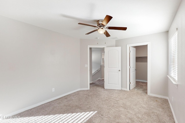 14813 Pebble Hills Blvd, El Paso, TX 79938 - unfurnished bedroom with light carpet, a spacious closet, baseboards, a ceiling fan, and a closet