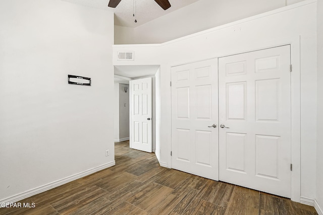 3400 Buffalo Soldier Cir, El Paso, TX 79936 - unfurnished bedroom with dark wood-type flooring, a closet, baseboards, and a ceiling fan