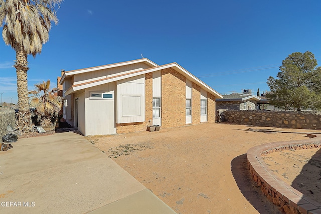 3400 Buffalo Soldier Cir, El Paso, TX 79936 - view of side of property with brick siding, fence, and a patio