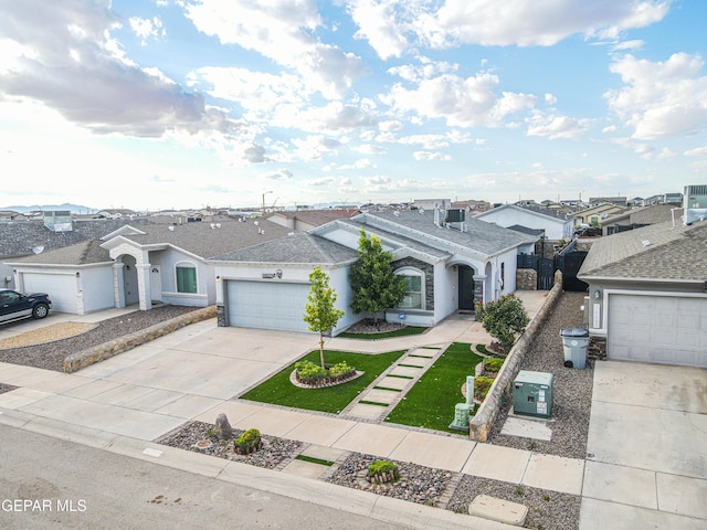 14837 Tierra Crystal Ave, El Paso, TX 79938 - view of front facade featuring driveway, an attached garage, stucco siding, and roof with shingles