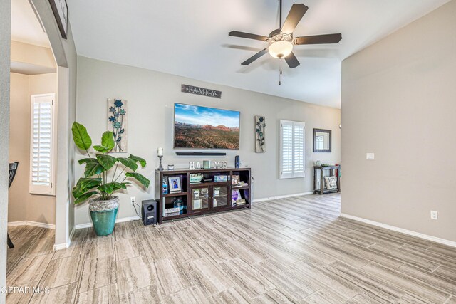 14837 Tierra Crystal Ave, El Paso, TX 79938 - living room with light wood-style floors, ceiling fan, baseboards, and lofted ceiling