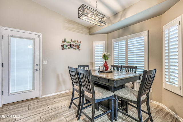 14837 Tierra Crystal Ave, El Paso, TX 79938 - dining room featuring light wood-style flooring, vaulted ceiling, a chandelier, and baseboards