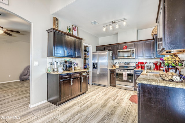 14837 Tierra Crystal Ave, El Paso, TX 79938 - kitchen with stainless steel appliances, wood tiled floors, decorative backsplash, a ceiling fan, and dark brown cabinetry