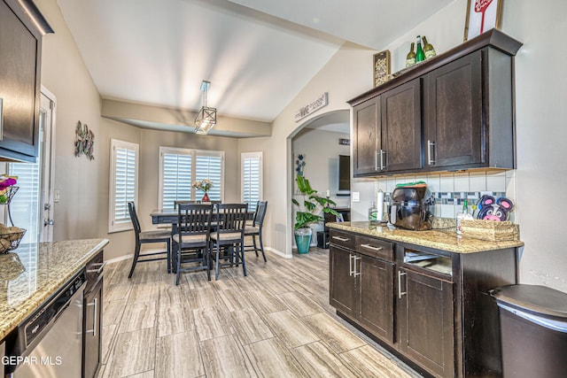 14837 Tierra Crystal Ave, El Paso, TX 79938 - kitchen featuring stainless steel dishwasher, dark brown cabinets, tasteful backsplash, light stone counters, and lofted ceiling