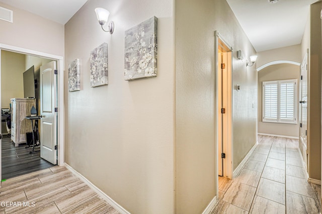 14837 Tierra Crystal Ave, El Paso, TX 79938 - hall with wood finish floors, arched walkways, and baseboards