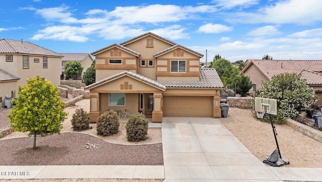 5525 Valley Cedar Dr, El Paso, TX 79932 - view of front of house featuring a tile roof, stucco siding, concrete driveway, and an attached garage